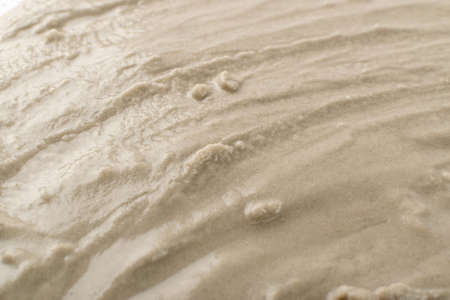Light beige wet sand texture pattern, damp sandy beach textured background top view with copy spaceの写真素材