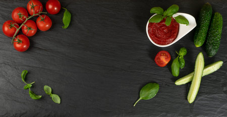 Dark Stone Background with Fresh Vegetables and Greens. Natural Flat Lay Mockup with Tomatoes, Basil...