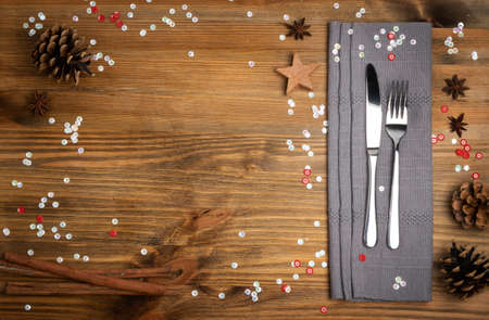 Christmas Dinner Table Setting with Cutlery, Gray Napkin and Winter Spices Top View. Festive Restaurant Decoration Background for Xmas Lunch, Dining invitation or Party with Copy Spaceの写真素材