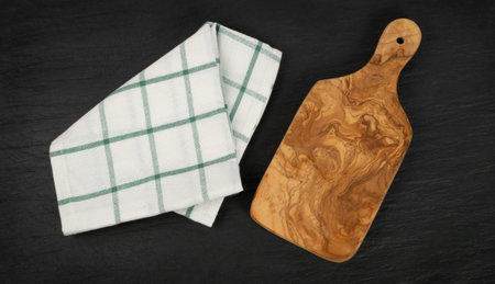 Olive wood cutting board with a rustic napkin mock up. Chopping board background with copy space top...