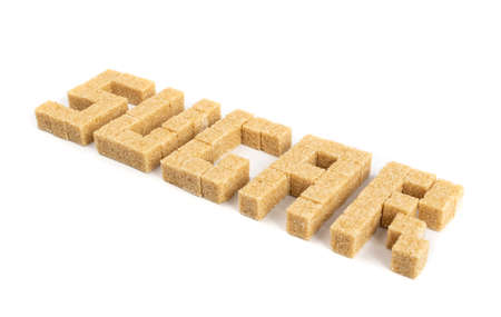 Sugar word made of raw brown sugar cubes isolated on white background. Unrefined cane sugar cubesの写真素材
