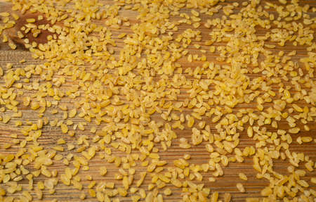 Bulgur grains texture background. Raw bulghur, dry cracked parboiled wheat groats, cereal food top viewの写真素材