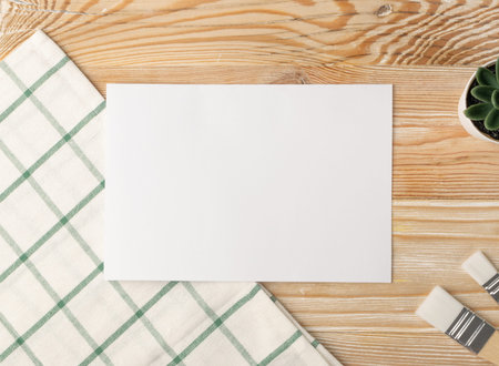 Minimal artist mockup with brushes on wood table flat lay and top view. White paper mock up...