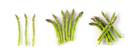 Bunches of Raw Garden Asparagus with Shadow Isolated. Fresh Green Spring Vegetables on White Background. Edible Sprouts of Asparagus Officinalis Top Viewの写真素材