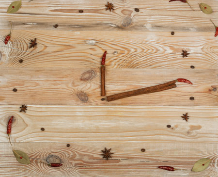 Clock Made of Cinnamon Sticks and Spices on Wood Background top Viewの写真素材