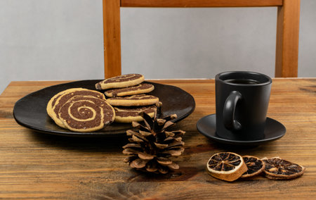 Spice cinnamon cookie with chocolate, zest and nuts filling on wood background. Brown and white...