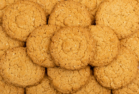 Thin oatmeal cookies texture background. Healthy cereal oat crackers pattern, anzac biscuit cookie...