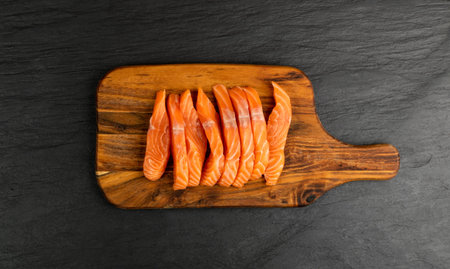 Slices of Raw Salmon Fillet on Black Background Mockup Top View. Thick Pieces of Fresh Red Fish or...