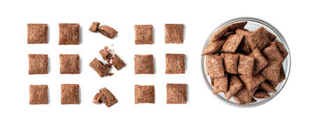 Set of chocolate pillows for breakfast isolated on white background. Brown choco cereal pads with cream, crispy corn flakes collection, healthy sweet snackの写真素材