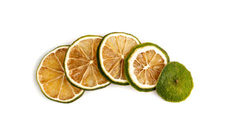 Dried lime slices line isolated on white background. Dry green lemon row top viewの写真素材