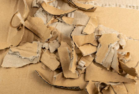 Cardboard Pieces Textured Background. Carton Piece with Copy Space, Ripped Kraft Paper Wallpaper, Brown Wrapping Vintage Paper Top Viewの写真素材
