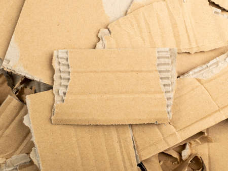 Cardboard Pieces Textured Background. Carton Piece with Copy Space, Ripped Kraft Paper Wallpaper, Brown Wrapping Vintage Paper Top Viewの写真素材