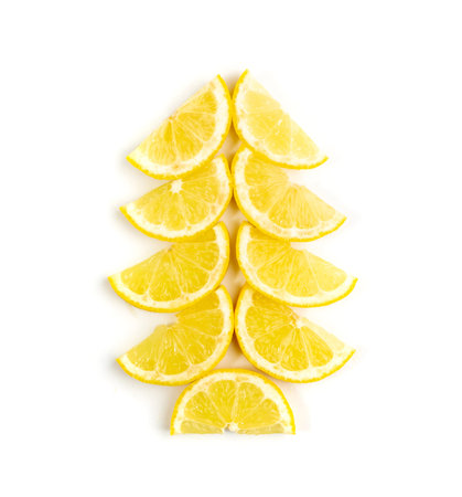 Christmas tree made of lemon slices isolated on white background. Lemons shaped of fir tree, winter party conceptの写真素材