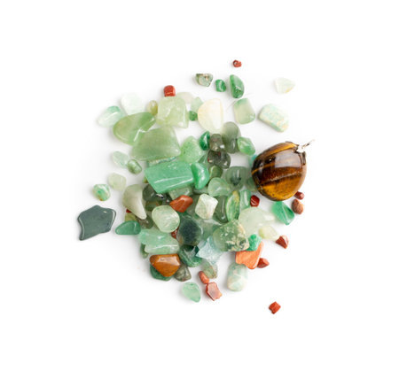 Colorful semiprecious stones mix isolated. Green, red, blue, white, black and purple quartz pebbles top viewの写真素材
