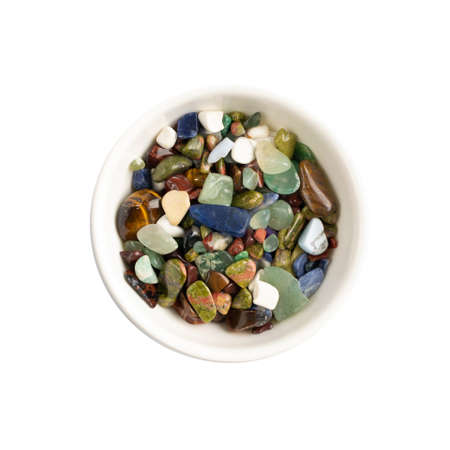 Colorful semiprecious stones mix isolated. Green, red, blue, white, black and purple quartz pebbles top viewの写真素材
