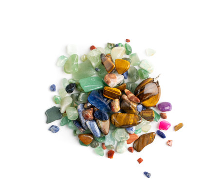 Colorful semiprecious stones mix isolated. Green, red, blue, white, black and purple quartz pebbles...