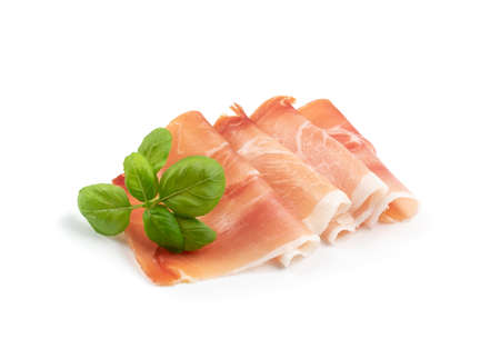 Slices of prosciutto isolated. Spanish jamon cut, parma ham, serrano or iberico on white background closeupの写真素材
