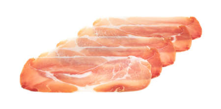 Slices of prosciutto isolated. Spanish jamon cut, parma ham, serrano or iberico on white backgroundの写真素材