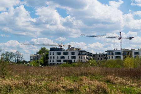 Warsaw, Poland - May 6, 2021: Modern apartment building construction. New residential building architecture, complex exterior, condominium facade with balconies and details, editorial image viewのeditorial素材