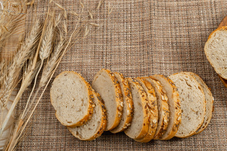 Homemade Sourdough Cereals Bread Loaf Slices on a Rustic Tablecloth Background. Crusty Cereal Bread...