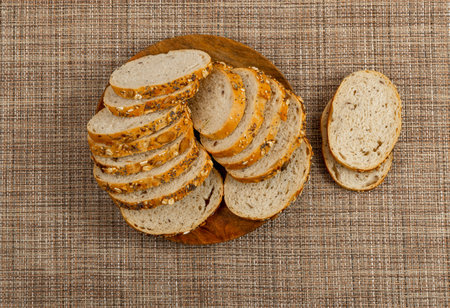 Homemade Sourdough Cereals Bread Loaf Slices on a Rustic Tablecloth Background. Crusty Cereal Bread...