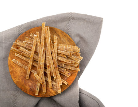 Dried fish sticks isolated. Dry salted seafood snack, hake stockfish, small pieces of dehydrated...