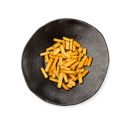 Homemade crunchy croutons with garlic, salt, herbs and spices isolated. Spicy bruschetta crackers,...