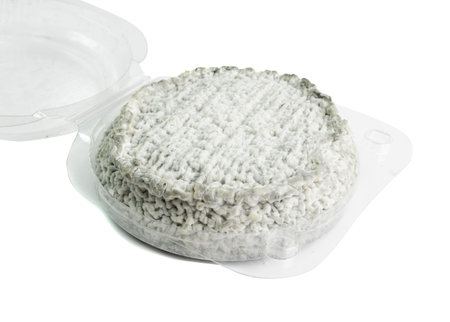 Traditional french Selles sur Cher cheese. Odorous cheese in a plastic package, rare goat cheese with blue mold and charcoal powderの写真素材