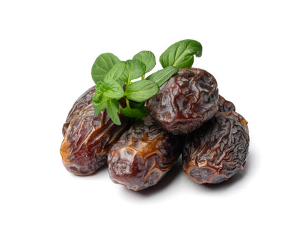 Big dates isolated. Dry date fruits heap, medjool, medjoul or majhool, royal dates with green leaves...