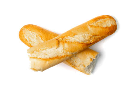 Broken French baguette isolated. Long bread loaf, two pieces of fresh cereal bun, traditional wheat baguette on white background top viewの写真素材