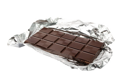 Chocolate bar on silver foil isolated. A whole chocolate blok with square segments in foil packaging...
