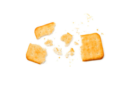 Cracker pieces isolated. Crumbed square biscuits, broken dry biscuit cookies, graham snacks on white background top viewの写真素材
