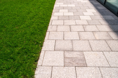 Modern paved path, new slab sidewalk, pathway through lawn, brick path road, tiles walkway with copy...