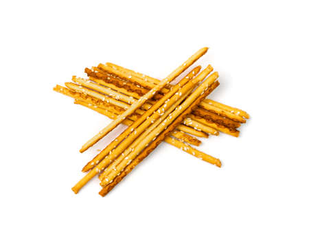 Bread stick isolated. Pretzel sticks pile, straws, sesame grissini, pretzels snack, breadstick with sesame seeds, long rusks on white backgroundの写真素材