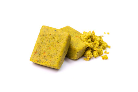Stock cube isolated. Crumbled vegetable stock concentrat, , broken broth cubes, bouillon cube, instant spice soup ingredient on white backgroundの写真素材