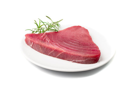 Raw tuna steak isolated. Red sea fish fillet, fresh tuna filet, seafood sashimi, bluefin piece, akami, ahi loin, albacore meat cut on white backgroundの写真素材