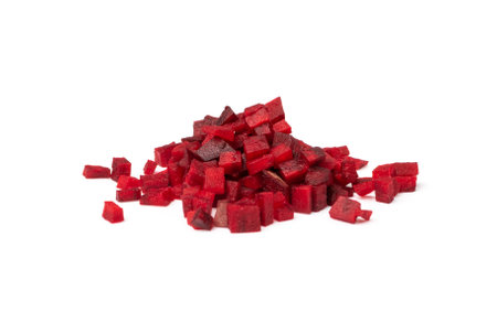 Beetroot cubes isolated. Finely diced red beet pile, small beet root pieces, chopped beetroot on white backgroundの写真素材