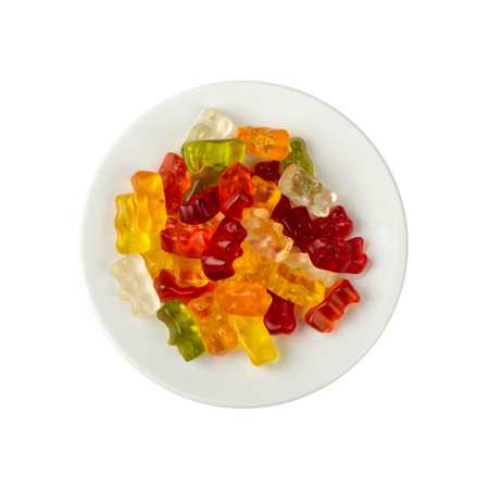 Gummy bears pile isolated. Chewing colorful marmalade, jelly bear heap, gelatin candy set on white plate background top viewの写真素材