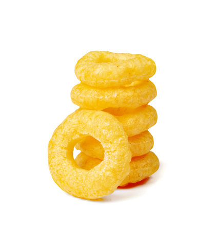 Corn rings pile isolated. Cereal puffs with spices, stack of round crunchy puffed snacks, breakfast...