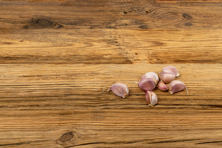 Garlic pile with copy space. Garlic clove group on wood rustic table background top viewの写真素材