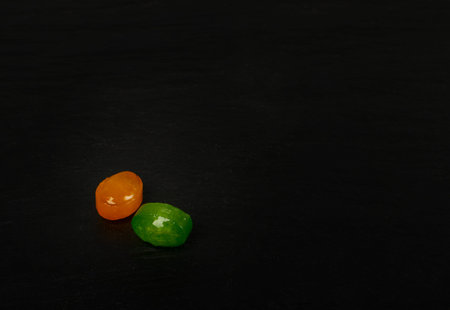 Colorful hard candies with copy space. Small shiny lollipop pile, fruit confectionery group, round...