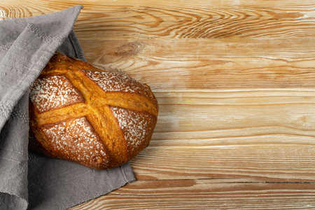 Homemade Freshly Baked Traditional Bread on Wooden Table. Rustic Cereal Bread Loaf with Space for...