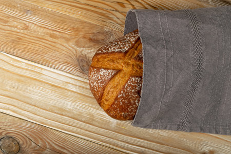 Homemade Freshly Baked Traditional Bread on Wooden Table. Rustic Cereal Bread Loaf Top View