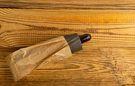 Black Hotdog on Wood Background, Dark Sausage Inside a Grilled Bun, Minimal Black Friday Hot Dog,...