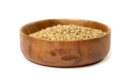 Raw Green Buckwheat Pile in Wood Bowl Isolated, Dry Buck Wheat Grains, Russian Kasha Heap, Uncooked Green Buckwheat Cut Out on White Background Side Viewの写真素材