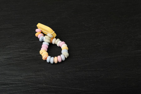 Tablet Candies Bracelet, Compressed Sugar Powder Confectionery, Dextrose Candy Necklace Parts, Lozenges on Black Backgroundの写真素材