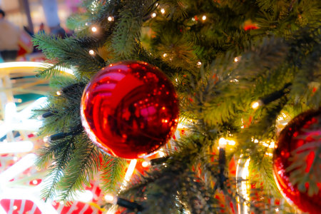 Decorated Christmas Tree, Christmas Decorations, Shiny Garland on Green Branches, Blurred Xmas Background with Copy Spaceの写真素材