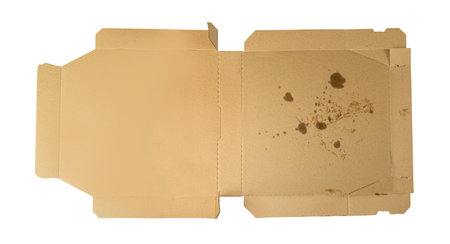 Empty pizza box isolated. Open delivery cardboard with crumbs, used greasy container, stained takeaway packaging, dirty pizza box on white background top viewの写真素材