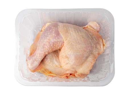 Raw Chicken Legs in a Plastic Container Isolated, Uncooked Poultry Drumsticks, Fresh Chicken Quarter on White Background with Clipping Path Top Viewの写真素材