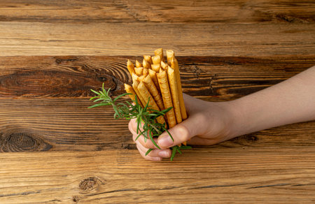 Bread Sticks in Hand, Salted Breadstick, Crispy Grissini, Dry Homemade Pretzels, Bread Stick on...